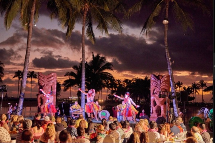 a group of palm trees in front of a crowd